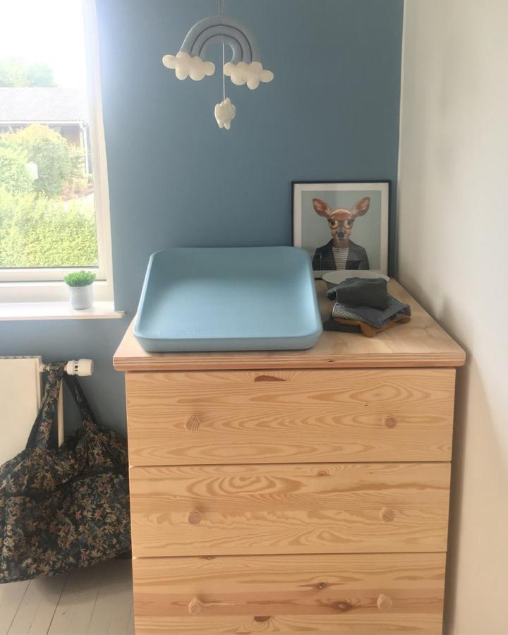 Natural pine Ikea Tarva dresser with a soft blue changing pad and nursery decor by @theresa.m.hjort in a cozy space.