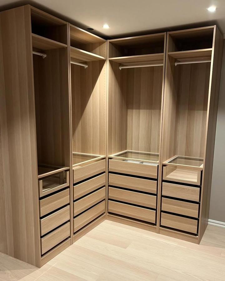 Light wood Ikea Pax dressing room ideas with elegant glass-top drawers from @chateau.slettholt. Modern, clean, and functional design.