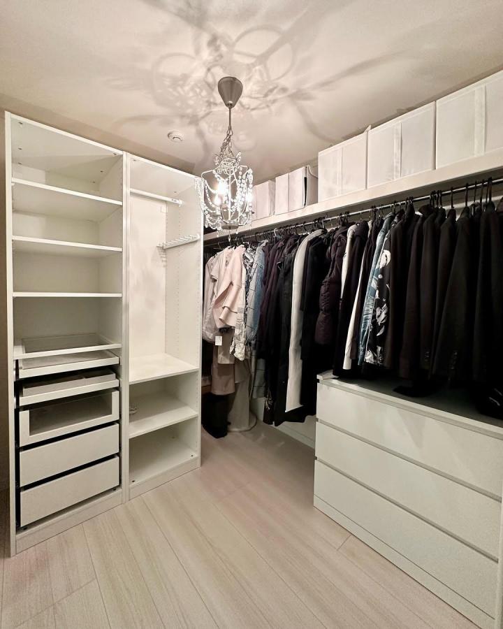 White and black wardrobe with chandelier from @a.myhome66. Ikea pax dressing room ideas with open shelves and drawers.
