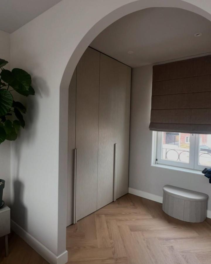 Textured beige door panels on ikea pax dressing room ideas by @studiofedde with natural light and soft decor.