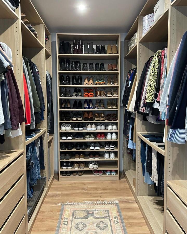 Light wood Ikea pax dressing room ideas shoe rack with multiple shelves from @seanuahouse showing organized footwear and matching wooden floors.