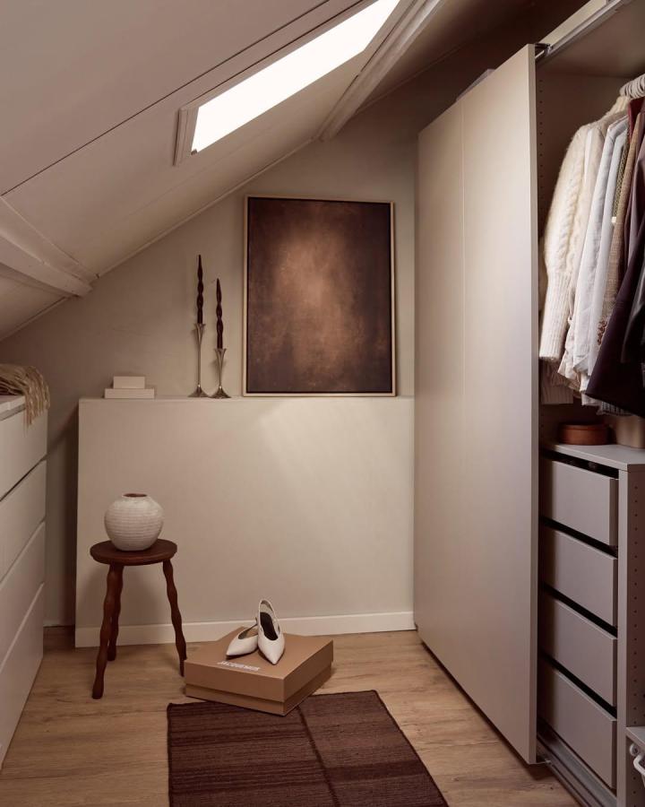 Muted beige ikea pax dressing room ideas by @nouveau.maison with minimalist white doors and wood accents. Cozy yet sleek space.