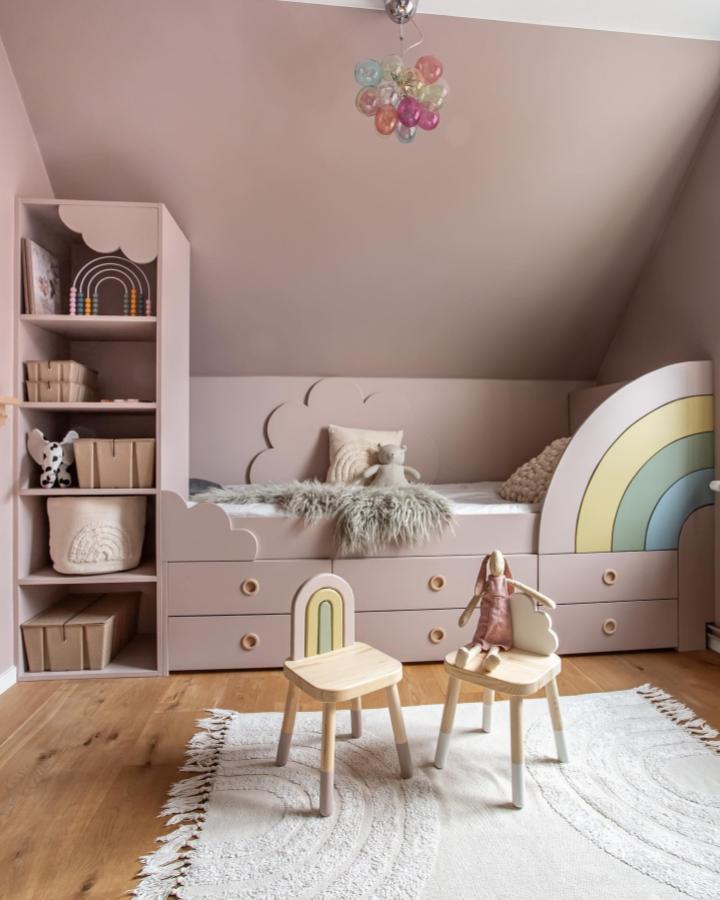 Blush pink kids room with pastel rainbows and natural wood stools from @designbycilla showcasing ikea platsa kids room ideas in a cozy setup.