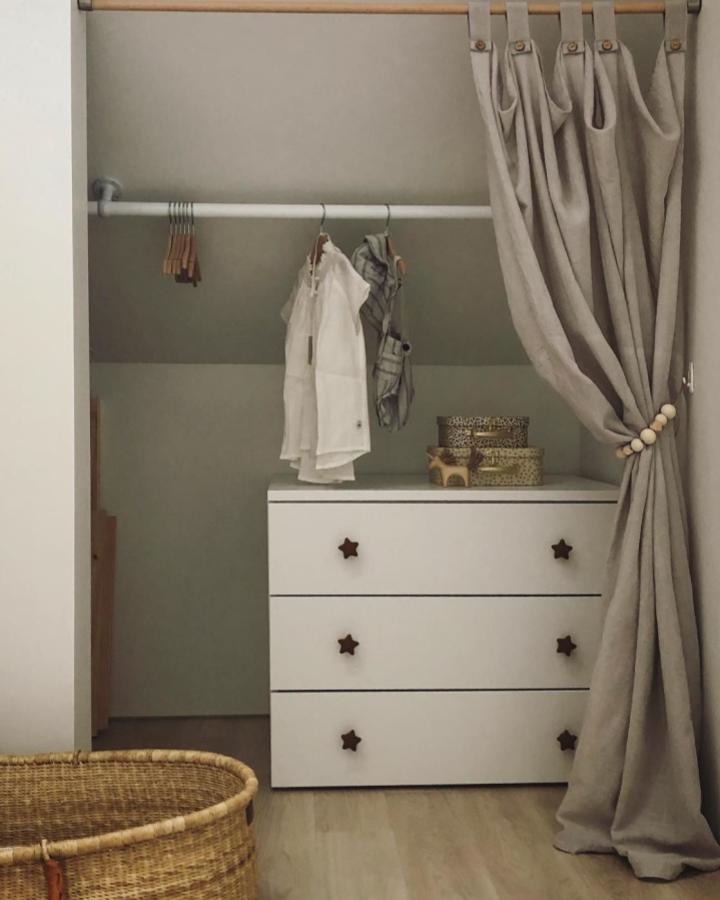White Platsa drawers with star-shaped knobs inside a neutral beige curtain closet from @osssaa_12. Cozy kids storage solution with hanging rail and natural textures.