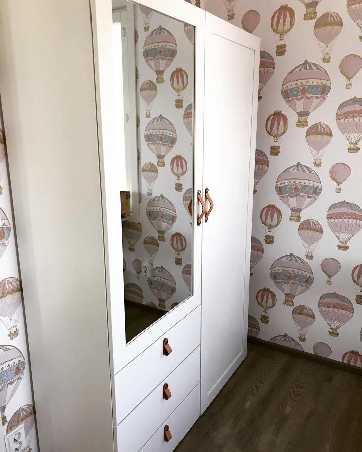 White Platsa wardrobe with leather handles and mirror door in kids room with hot air balloon wallpaper ikea platsa kids room ideas by @villavictoria