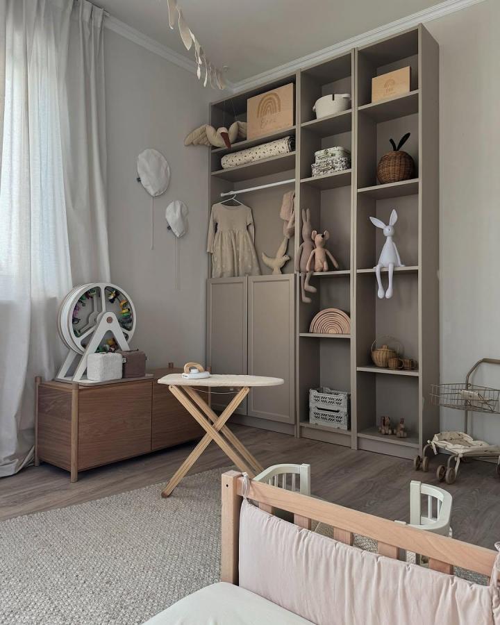 Taupe-colored Billy bookcase built in with mixed open and closed storage from @arcola_home featuring ikea billy bookcase built ins ideas for stylish kids room organization.