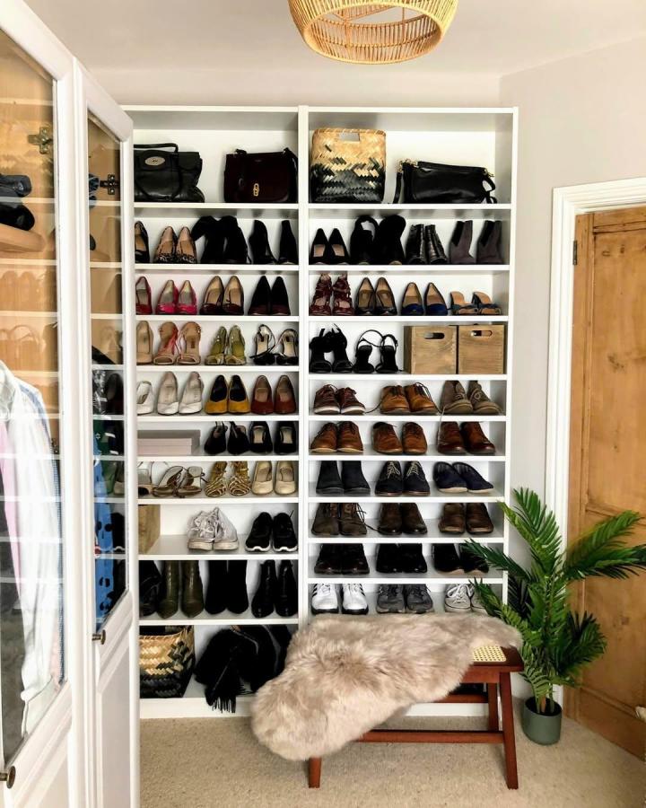 White Billy bookcase shoe storage with textured baskets and cozy bench from @ouracaciagrovehome in a neat closet corner.