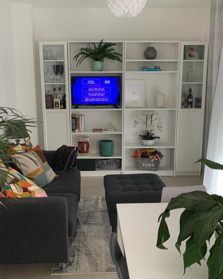 White Billy bookcase media wall with glass doors and decorative elements from @melman_house in cozy living room setting. Bright and organized.