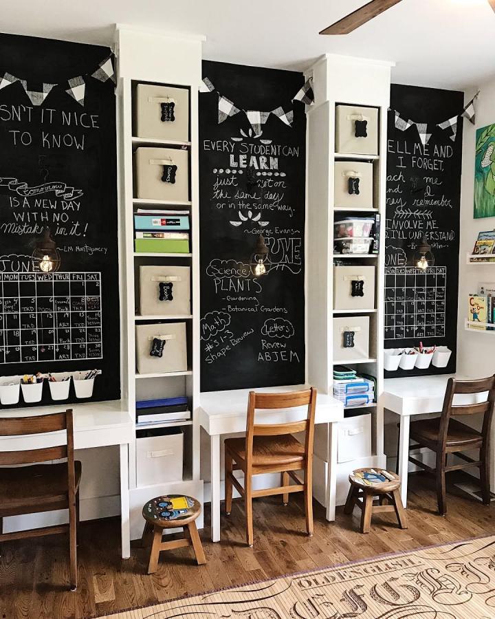 White Billy bookcases with chalkboard painted walls and fabric bins in a creative homework nook by @lifeonacountryroad. Rustic study space.