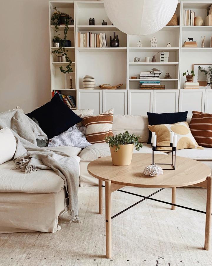 White minimalist living room built-in shelving from @hemmainteriors_ featuring combined Billy storage units with modern decorative accents and plants.