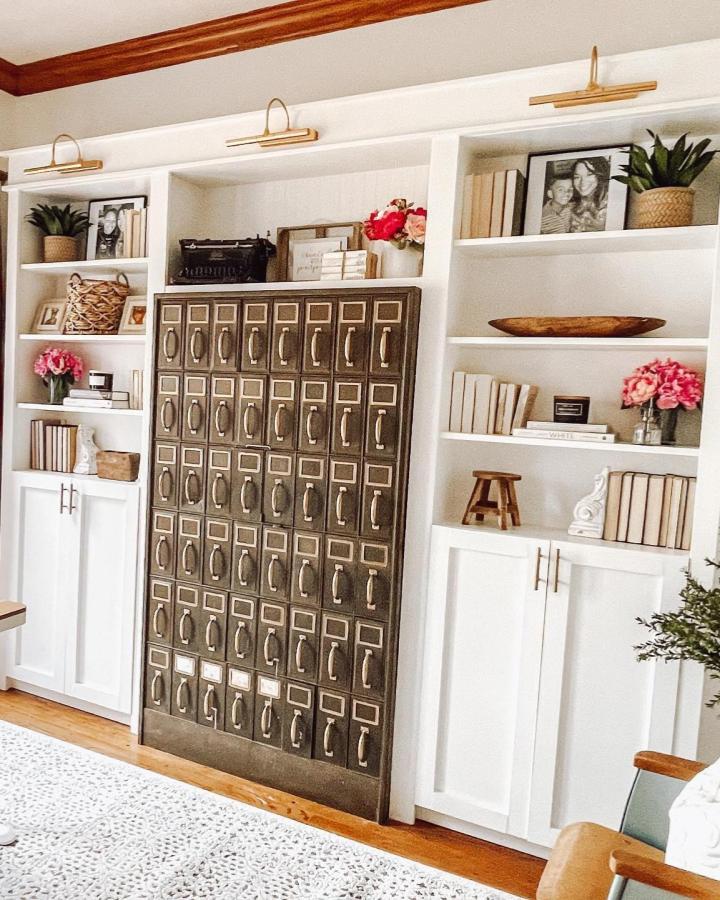 Dark metal vintage style cabinet with white built-in shelves from @athomewithastra. Functional rustic and modern decor blend.