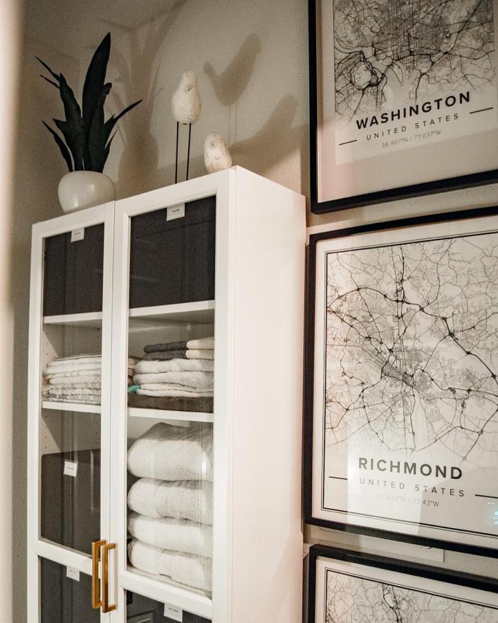 White Billy style cabinet with glass doors and gold handles from @this_is_home_design. Styled for organized linen storage and labeled fabric bins.