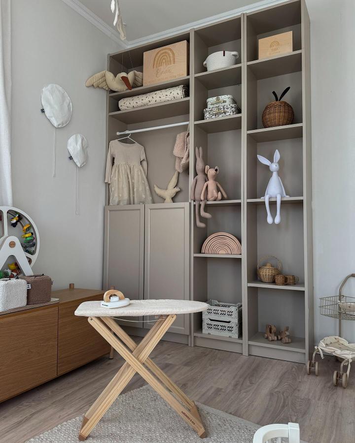 Muted beige children's room storage from @lisa_erhart with mixed open shelves and wardrobe hack for playful charm.
