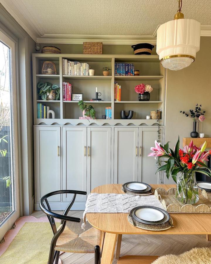 Soft grey Billy bookcase with shiplap detail and brass handles styled by @little_edwardian_semi featuring ikea billy bookcase styling with plants and books.