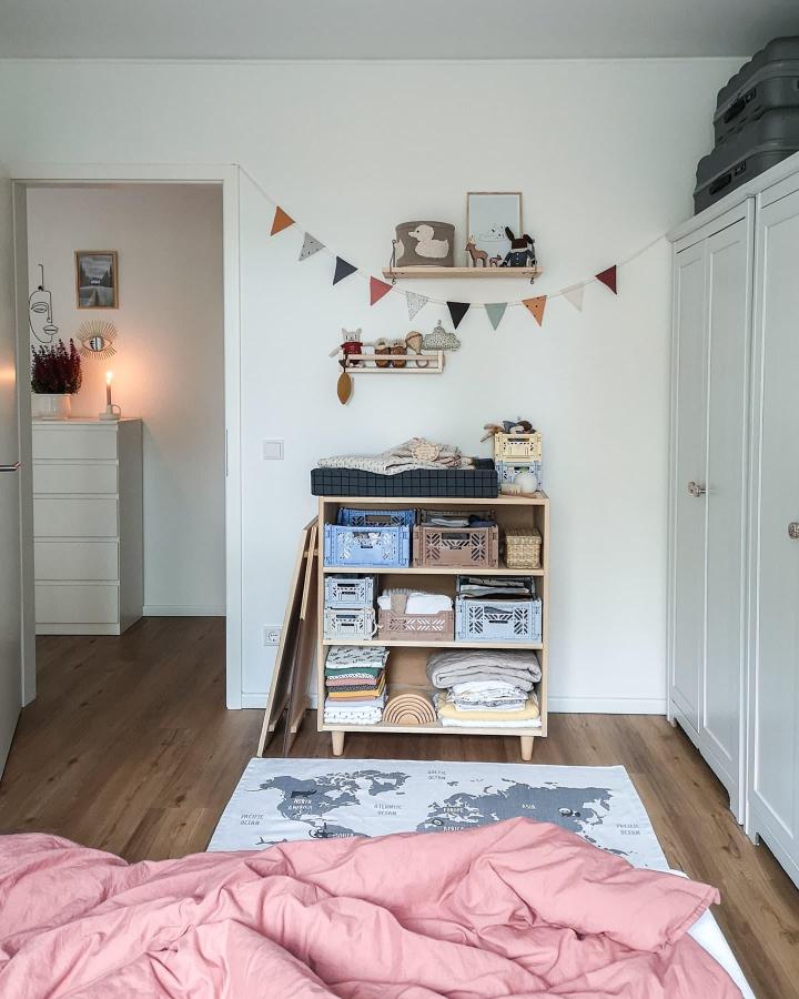 Natural wood Ikea Billy shelving unit styled with pastel storage crates in a minimalist kids room by @terrazzo.konfetti showcasing cozy organization and soft color accents