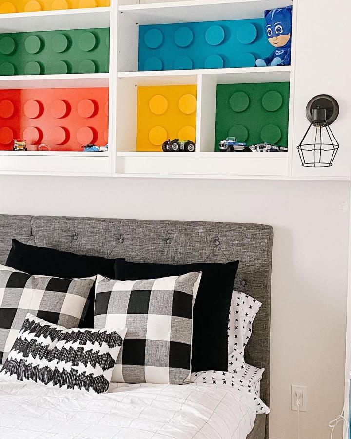 Bright Lego style colorful shelving in ikea billy kids room ideas by @d.n.a.designs featuring playful storage panels.