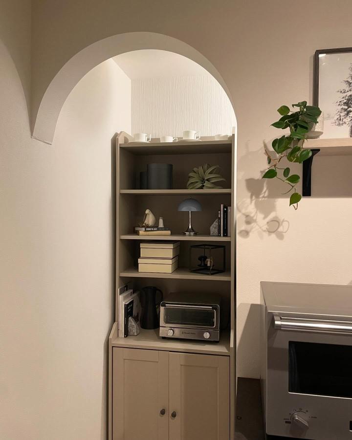 Neutral beige shelving unit with kitchen appliances and decor by @yuko_la_nostra_casa shown in a stylish minimalist kitchen corner. Cozy and functional design.