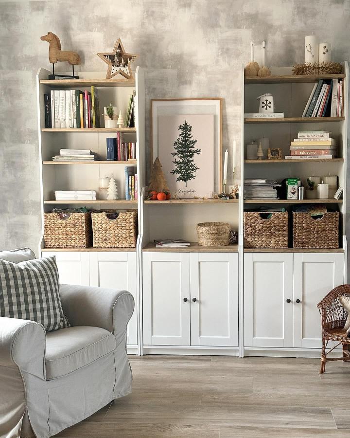 Woven basket and white wood shelving unit living room storage by @lesbricolesdaude with natural decorative elements. Cozy and organized space.