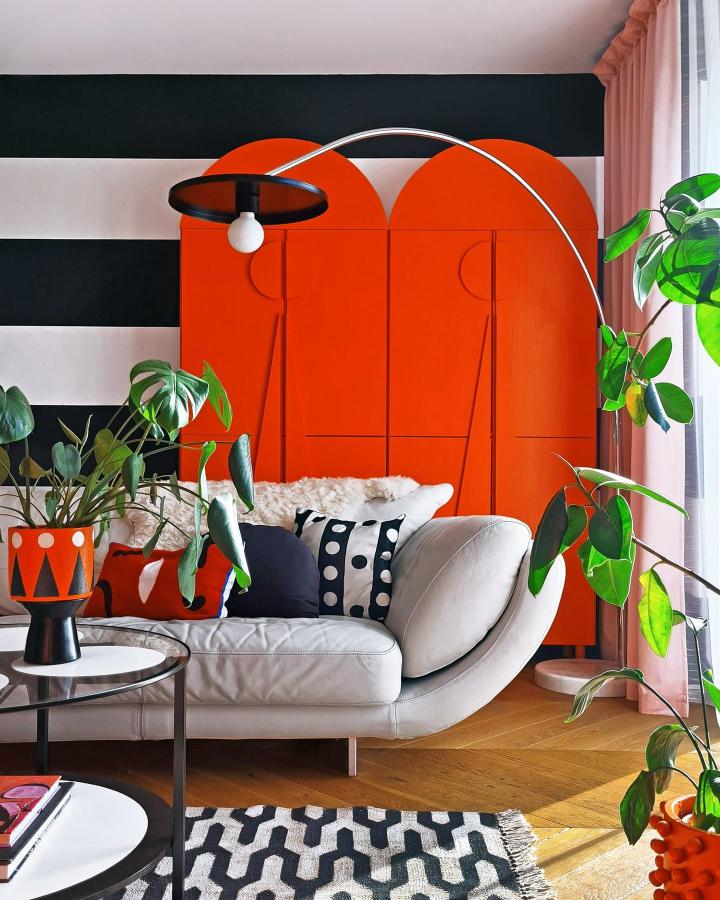 Bright orange arched homemade cabinet in living room from @megmonde. Stylish and energetic furniture makeover with playful details.
