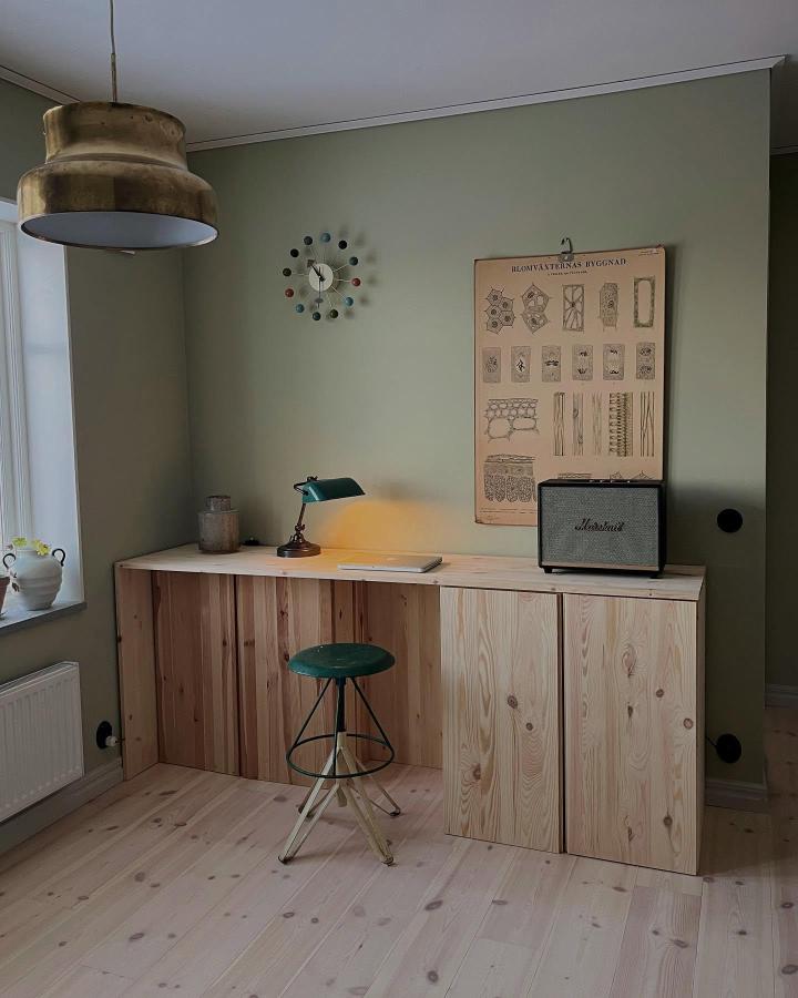 Natural pine wood furniture piece from @honey.thistle. Minimalist workspace with smooth flat surfaces and hidden storage panels.