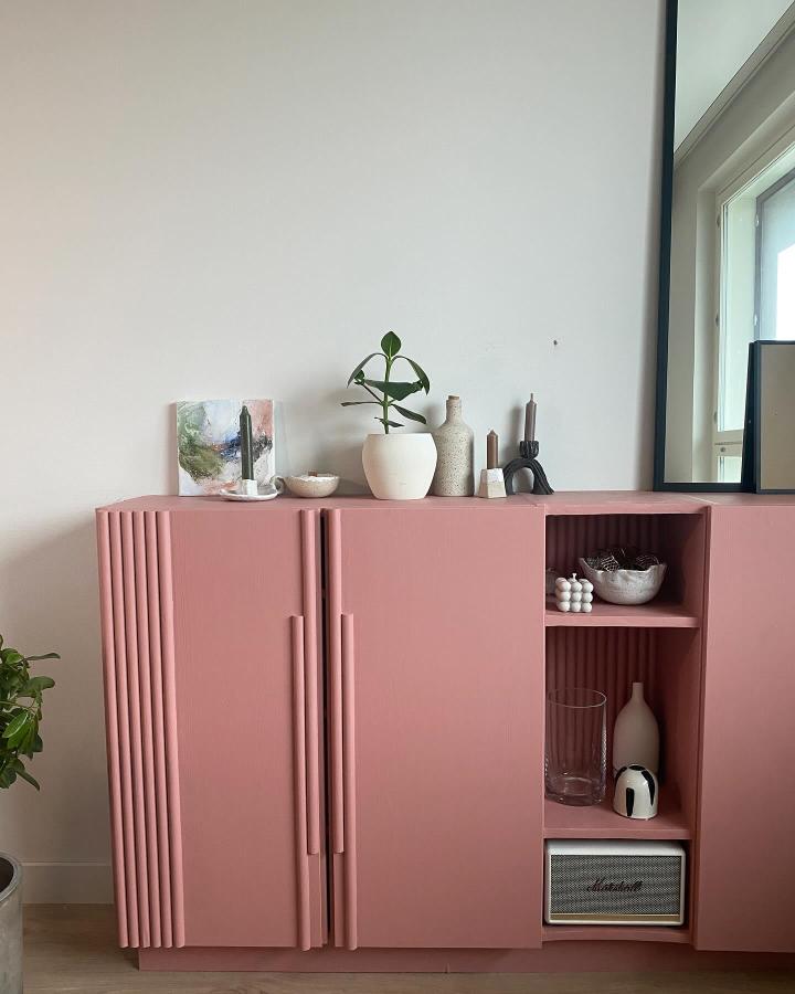 Pink matte textured storage cabinet with open shelves and decorative ceramics from @the_kiyomi_ showing creative wooden furniture transformation.