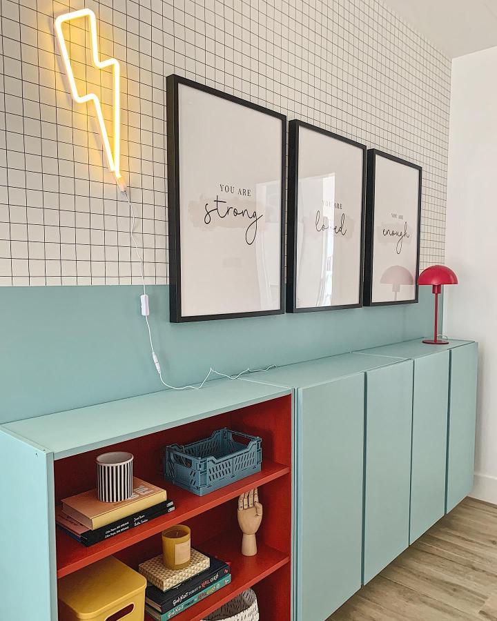 Mint green and bright red painted Ikea Ivar cabinet hack with modern doors and shelving from @bianca.interior.design in a stylish living space. Bright color contrast ikea ivar cabinet hacks.