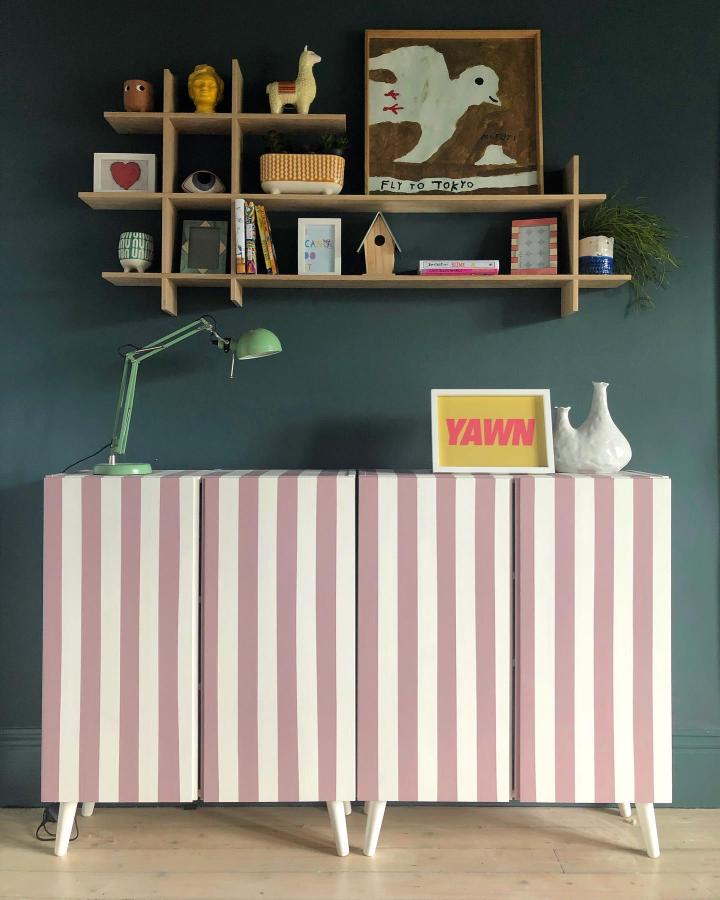 Pink and white striped painted cabinet with angled legs in a home setting by @makienverkroost fresh modernized storage piece.