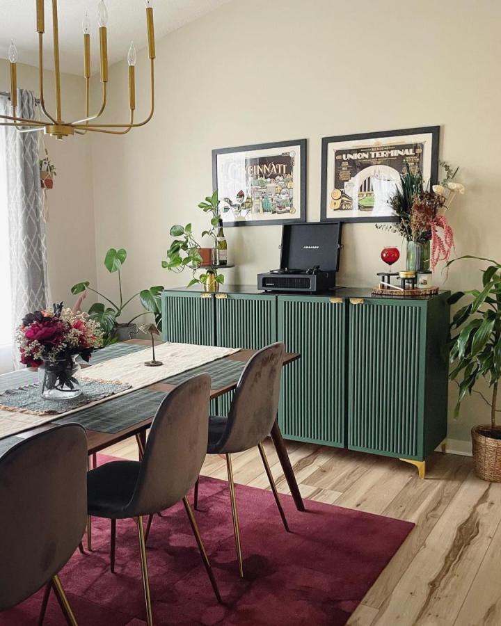 Elegant deep green slatted door ikea ivar cabinet hacks by @thequeenofkingman in dining room with brass accents and plants.