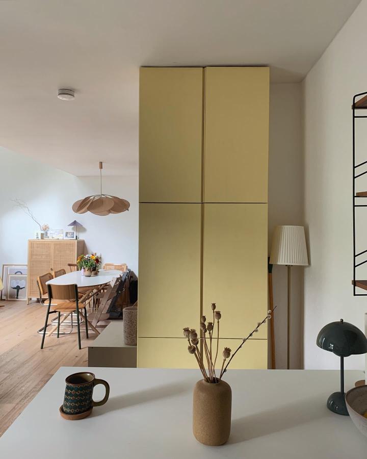 Soft matte yellow tall storage cabinets in a modern home setting by @ew_raumdetails with clean minimalist design and warm tones.