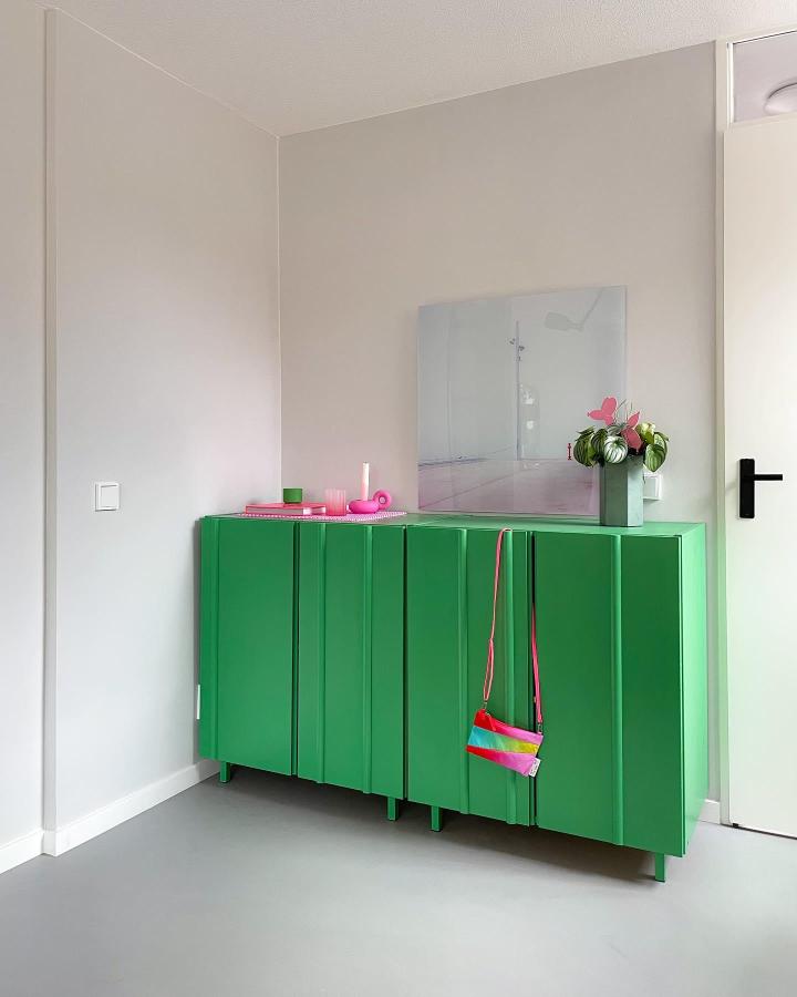 Green painted Ikea Ivar cabinet with custom legs in a minimalist room from @hiiitschristin. Vibrant ikea ivar cabinet hacks makeover.