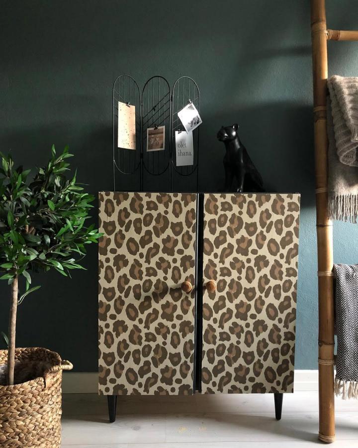 Cheetah print wallpaper on Ivar doors with wooden knobs in stylish room by @marialovesrealestate ikea ivar door hacks. Bold and unique design.