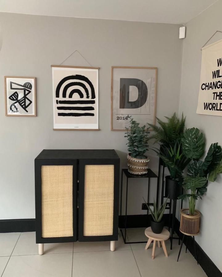 Black framed cabinet with woven cane doors and light wooden legs in a modern living space by @jayne.s.davies minimalist style storage piece.