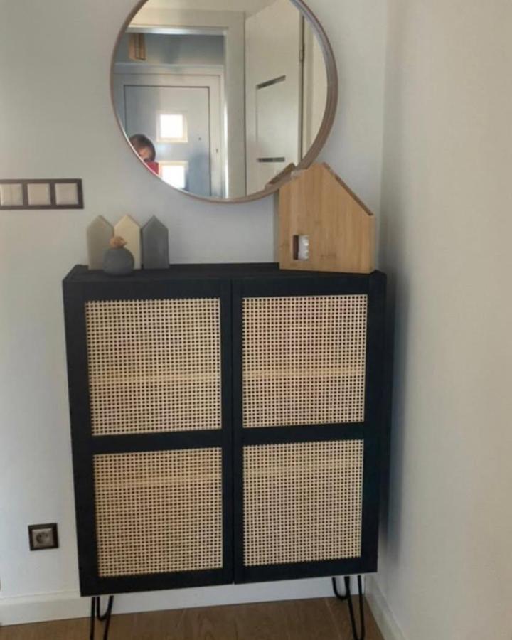 Black chalk painted wood framed cabinet with natural rattan panels in modern storage design by @adasobocinska simple and elegant style.