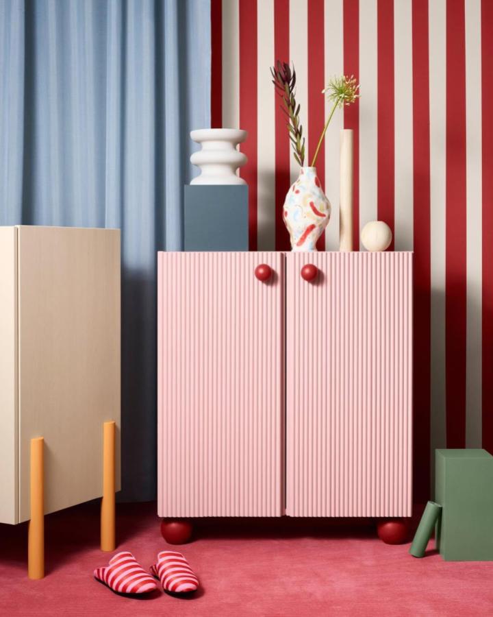 Pink fluted panel cabinet with rounded knobs and feet in a colorful room from @prettypegs. Textured decorative furniture transformation.