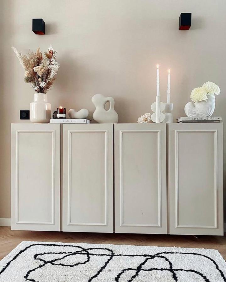 Beige painted Ivar style cabinet doors with added molding and minimalist decor from @headofswans. Classic yet modern look.
