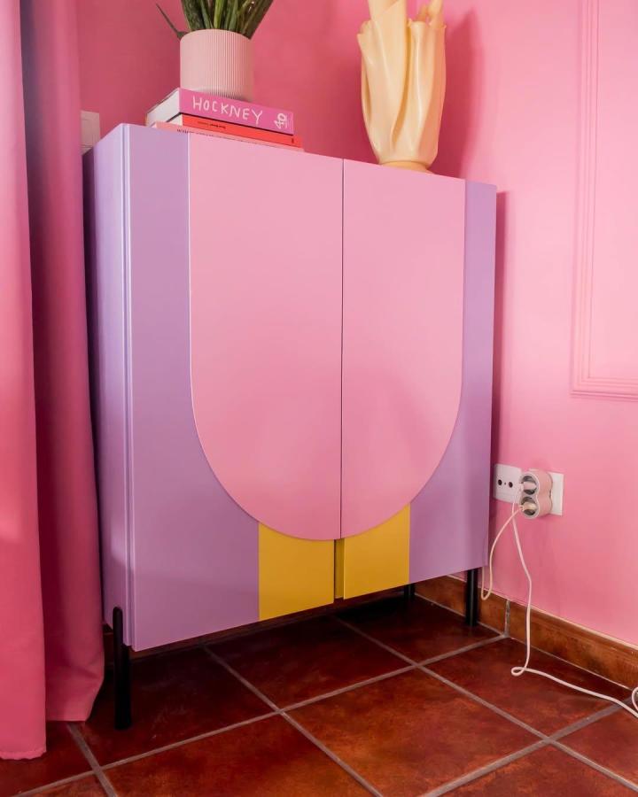 Pink lavender and yellow painted cabinet with custom arch wooden door cut-outs by @the_kiyomi_ showing creative Ivar furniture makeover.