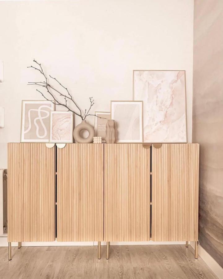 Beige textured wooden cabinet doors with glued rods in a modern living room from @my_littleessence showing creative natural wood detail.