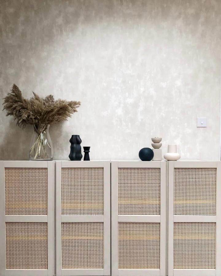 Beige rattan door cabinet upgrade in neutral room from @houseofyooni. Natural textured woven doors on classic storage unit.