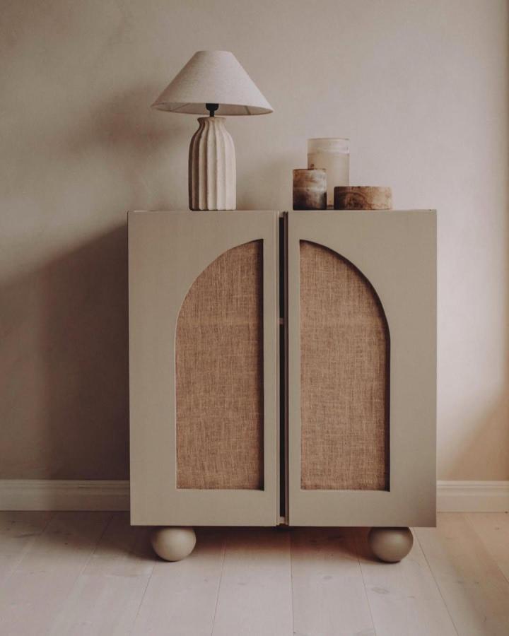 Beige painted cabinet doors with half-arch cutouts featuring lusern fabric panels and ball feet by @sanna.emelie Cozy, stylish storage makeover.