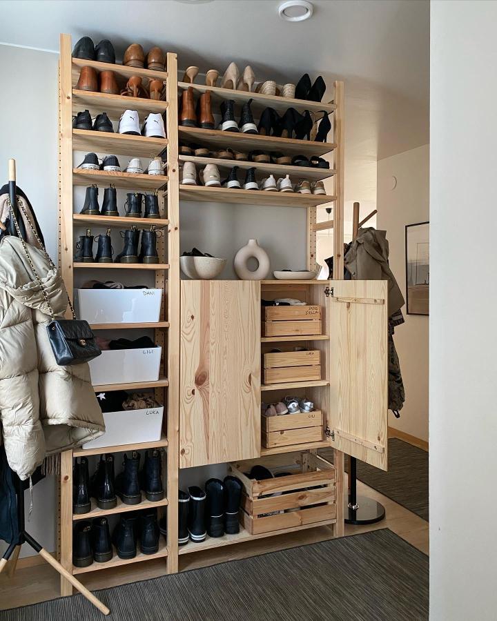 Natural pine shoe storage system with wooden crates and open shelves from @by.anna.b showcasing a stylish organized entryway makeover.