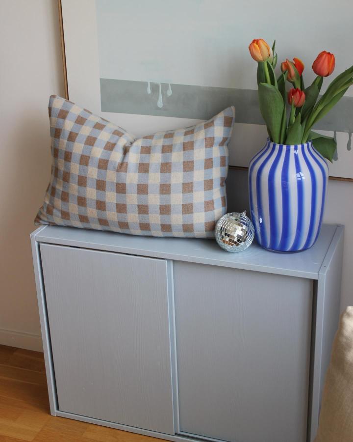 Pastel painted Ivar cabinet with checkered pillow and striped vase from @mathildas_kvadrat. A stylish, cozy home storage update.