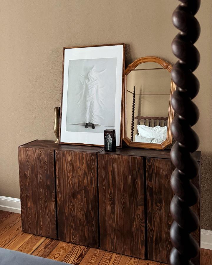 Dark stained wooden Ikea Ivar cabinets with natural wood grain texture in a cozy room by @navasgeht simple elegant storage unit.