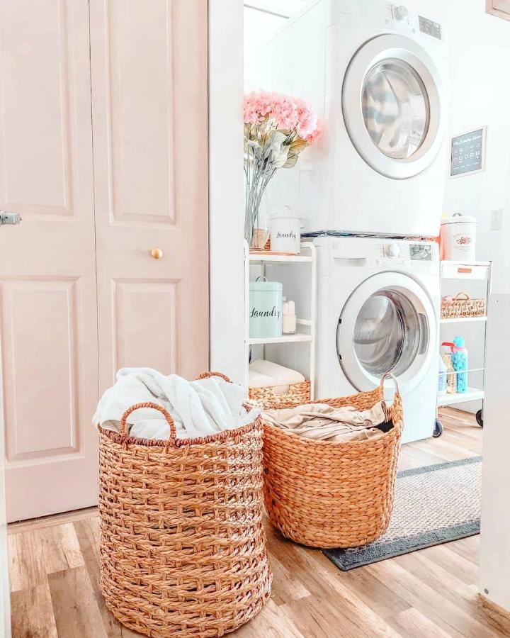 Natural woven baskets and white Ikea utility carts laundry nook from @theluxmylife. Cozy, organized space with texture and function.