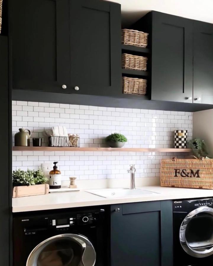 Dark matte IVAR cabinets and white subway tile with wicker baskets laundry room setup by @mrs_macs_home showing stylish storage and countertop sink area.