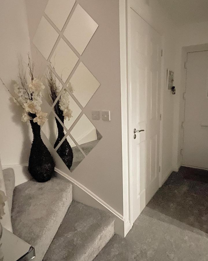 Neutral diamond grid mirror wall in entryway from @our_tuscanyhome Reflective panel arrangement brightens small hallway with cozy details.