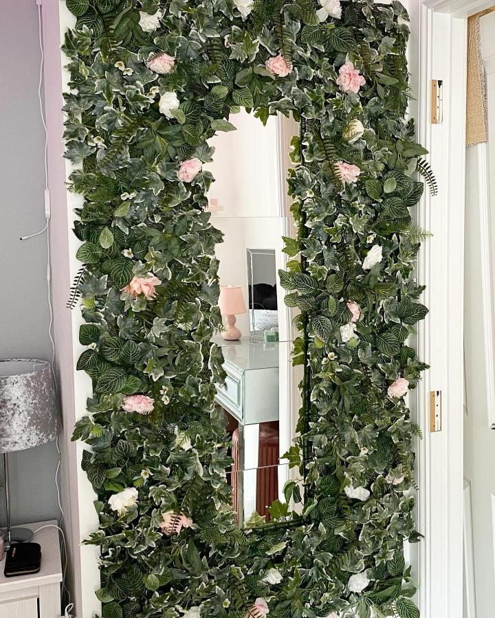 Lush green and floral framed ikea mirror wall from @our_forever_newbuild with detailed leaf textures and blooming accents.