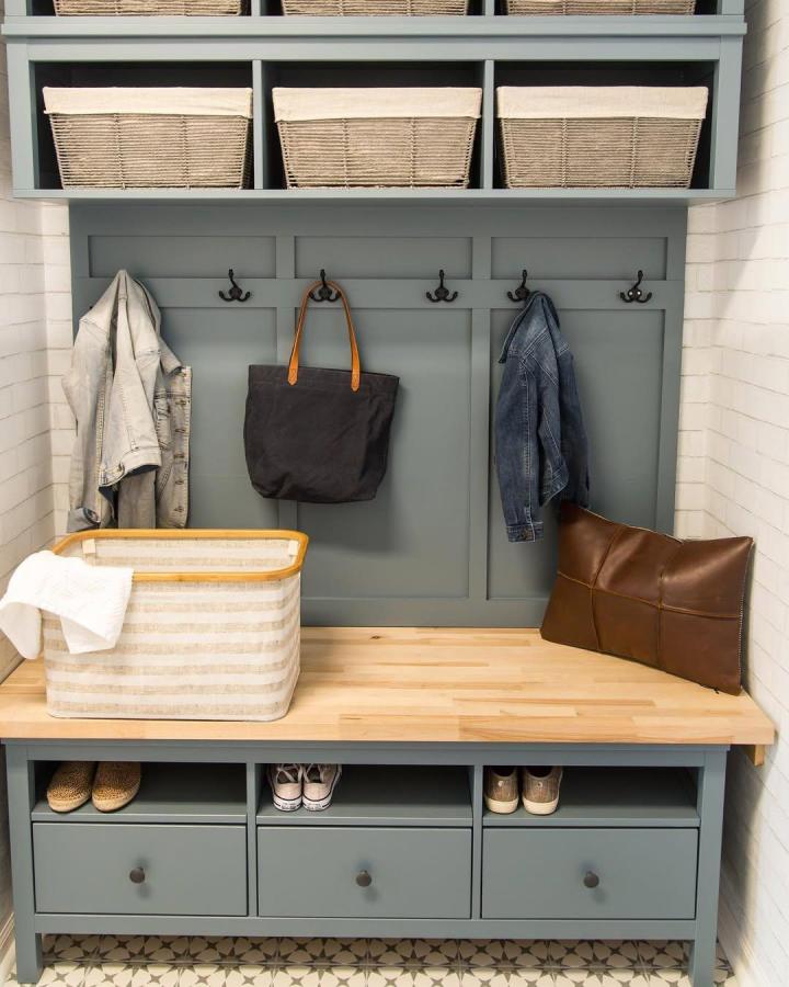 Blue gray IKEA Hemnes bench hack mudroom setup by @housebyhoff with wooden top, fabric-lined baskets, and hooks perfect for ikea mudroom hacks.