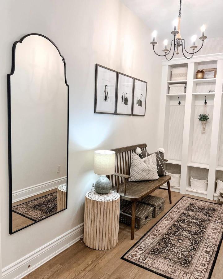 White beadboard backed Ikea Billy bookcases repurposed as mudroom cubbies with bench and baskets by @katrinalgallagher creating elegant ikea mudroom hacks.
