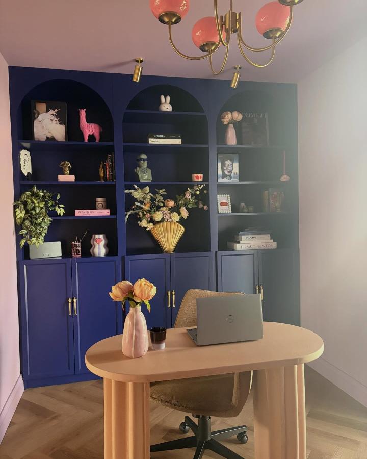 Navy blue arched painted ikea billy bookcase ideas with brass handles and decorative shelving by @villakakelgoud showcasing a stylish home office setup