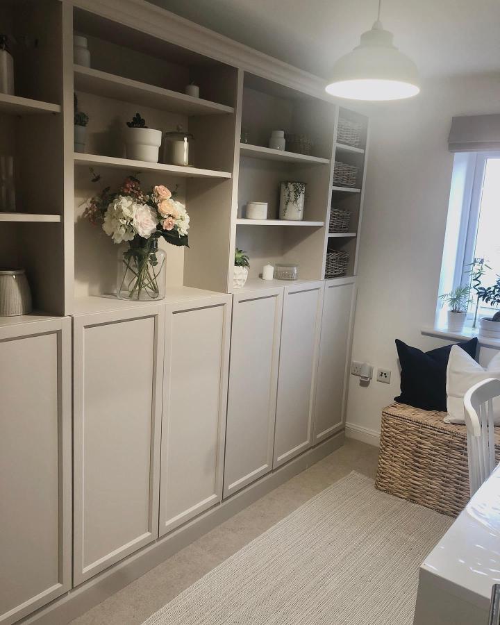 Soft greige painted Ikea Billy bookcase with matte finish and classic trim from @our_chaileyhome in cozy living space.